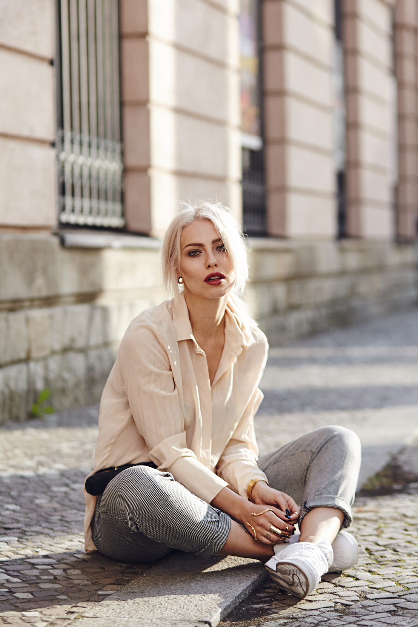 street style from Berlin via Masha Sedgwick | casual office fashion outfit | Masha is wearing Adidas Superstar sneaker, a black Elizabeth & James belt bag, a golden hand cuff, a nude silk shirt, a hound's-tooth checked pants