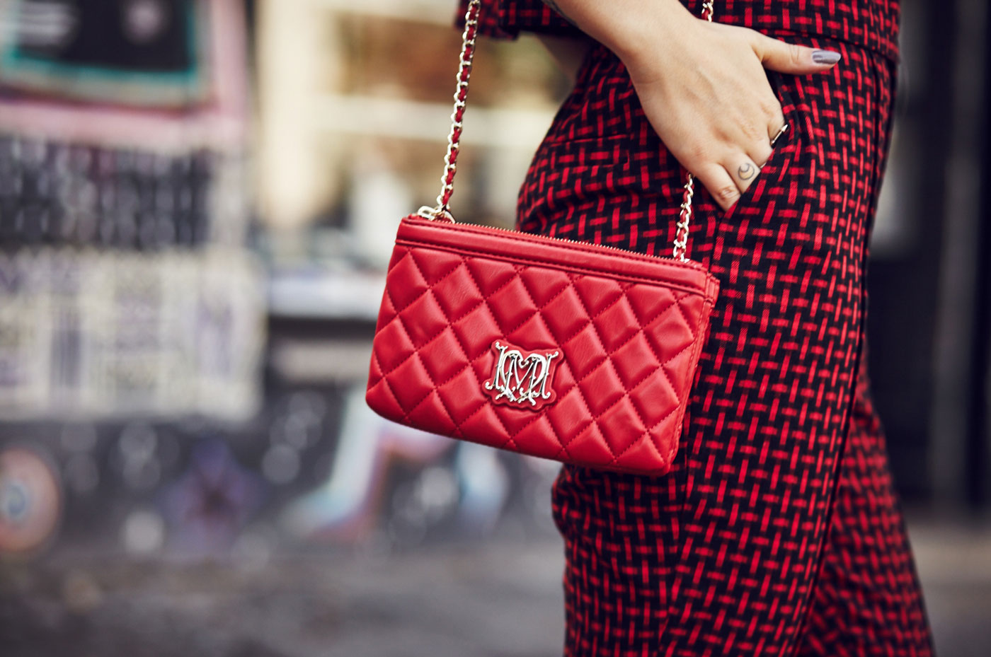 Masha Sedgwick, fashion blogger from Berlin is wearing a red two piece combined with a red Moschino bag and black loafers | Outfit