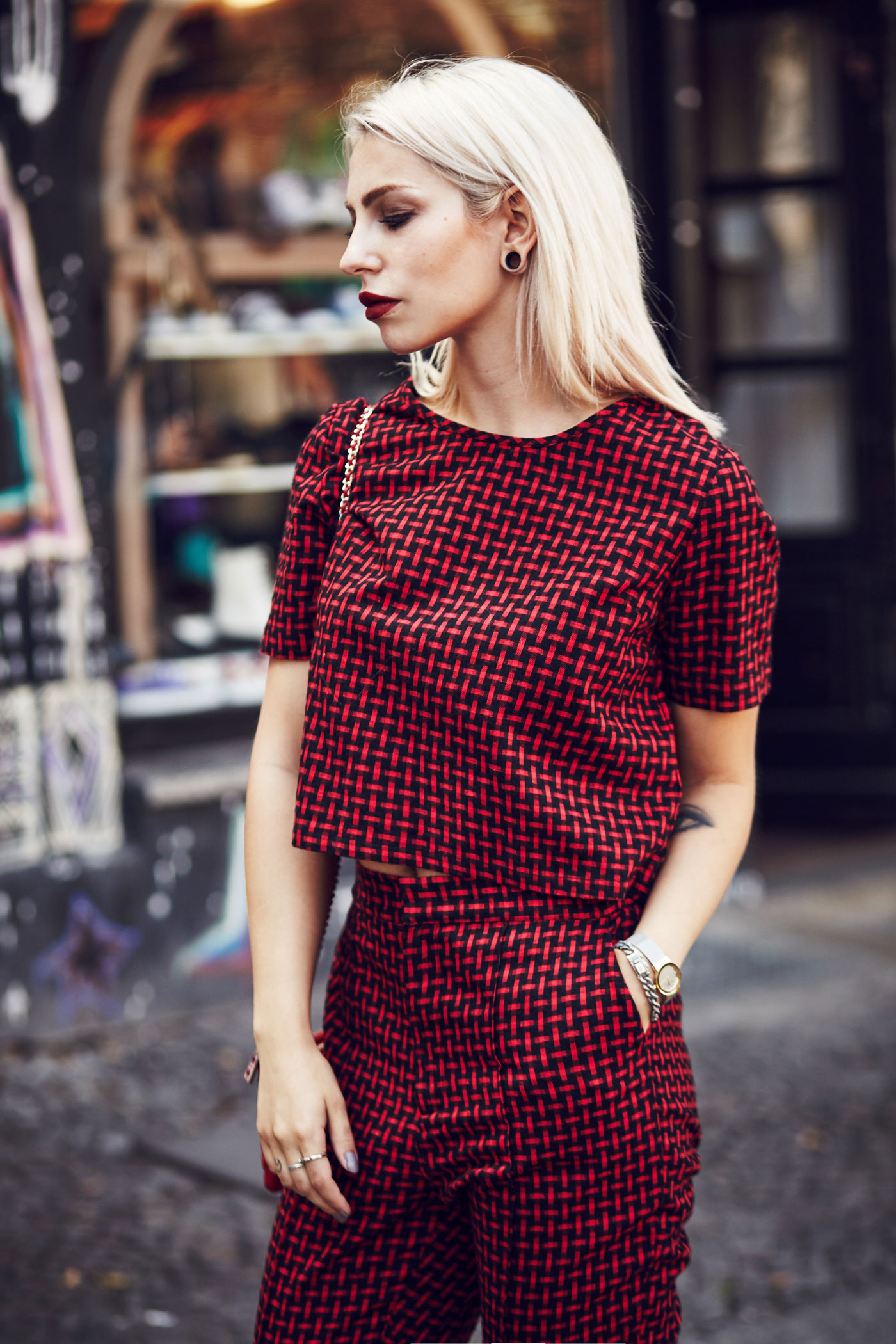 Masha Sedgwick, fashion blogger from Berlin is wearing a red two piece combined with a red Moschino bag and black loafers | Outfit
