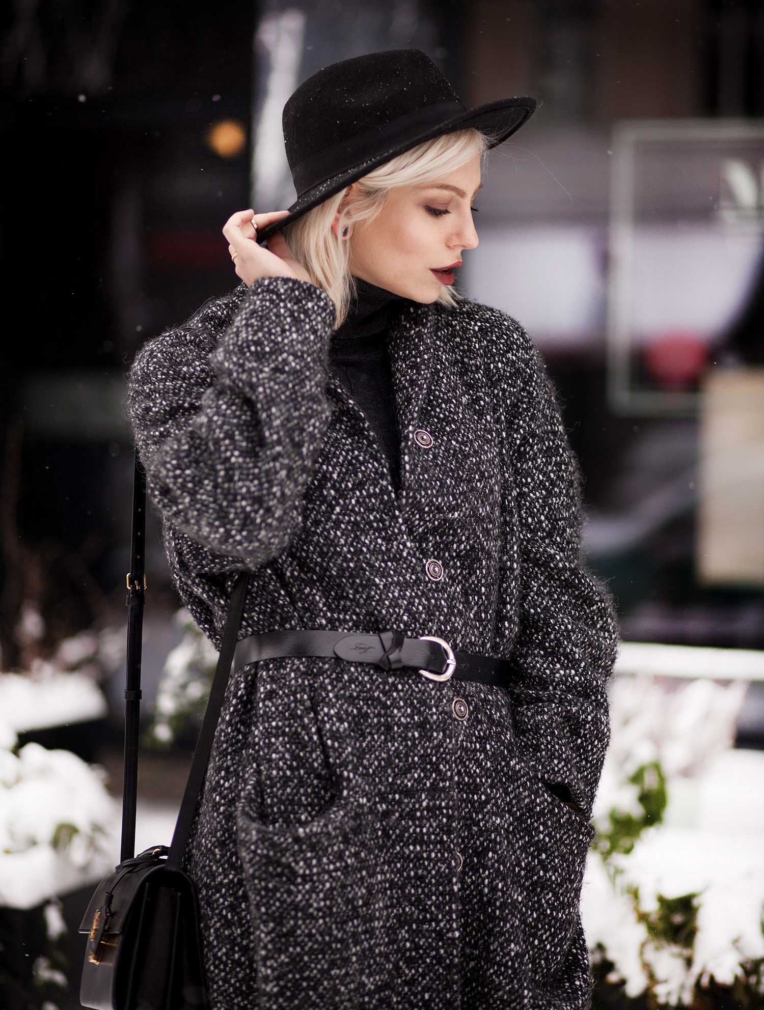 view more details on my blog | wearing black boots with a star from Love Moschino, an oversized wool coat from Marimekko, a black bag from Saint Laurent and a black jeans from AG | black, edgy, winter fashion | street style taken in Berlin | snow