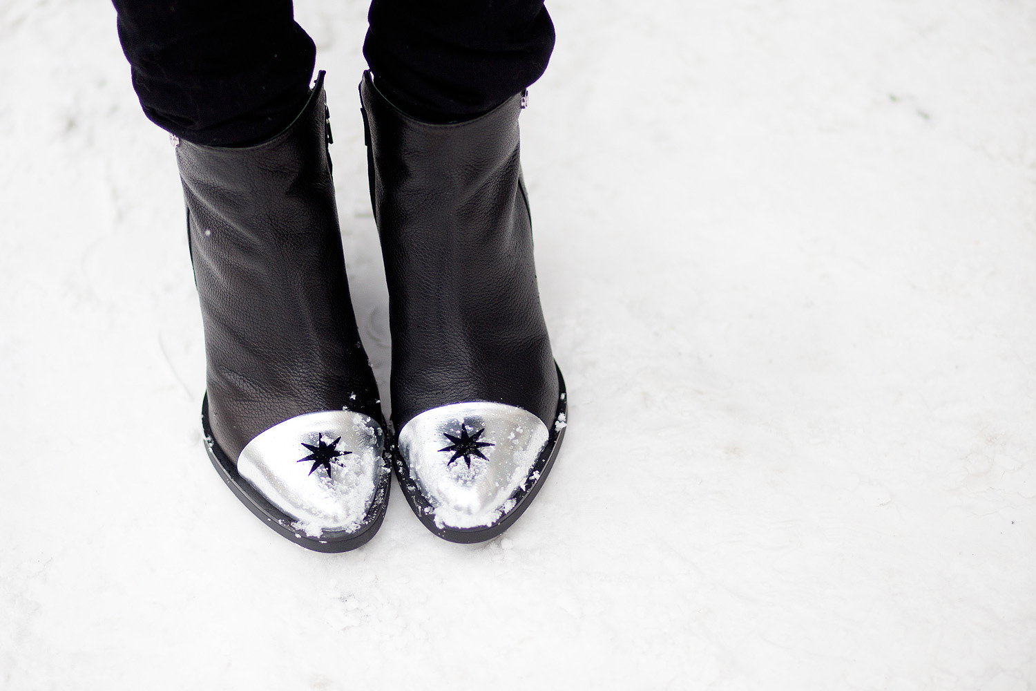 view more details on my blog | wearing black boots with a star from Love Moschino, an oversized wool coat from Marimekko, a black bag from Saint Laurent and a black jeans from AG | black, edgy, winter fashion | street style taken in Berlin | snow