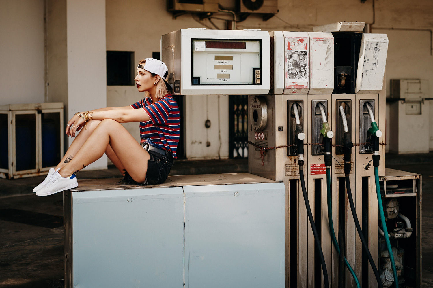 Editorial shooting location: Gas Station | sporty style | striped shirt from Iro Paris and vintage shirts | sneakers from Reebok x Face collection