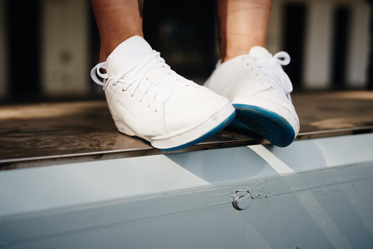 Editorial shooting location: Gas Station | sporty style | striped shirt from Iro Paris and vintage shirts | sneakers from Reebok x Face collection