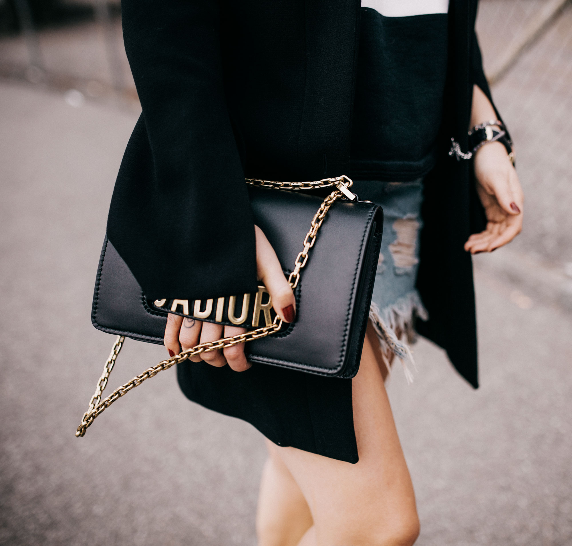 Fashion Editorial shooting with street art | style: rock, edgy, grunge, summer, dark, black, cool, industrial | wearing a Zara denim skirt, an oversized black blazer, cut out boots from 3.1. phillip Lim and an opening ceremony sweater tee