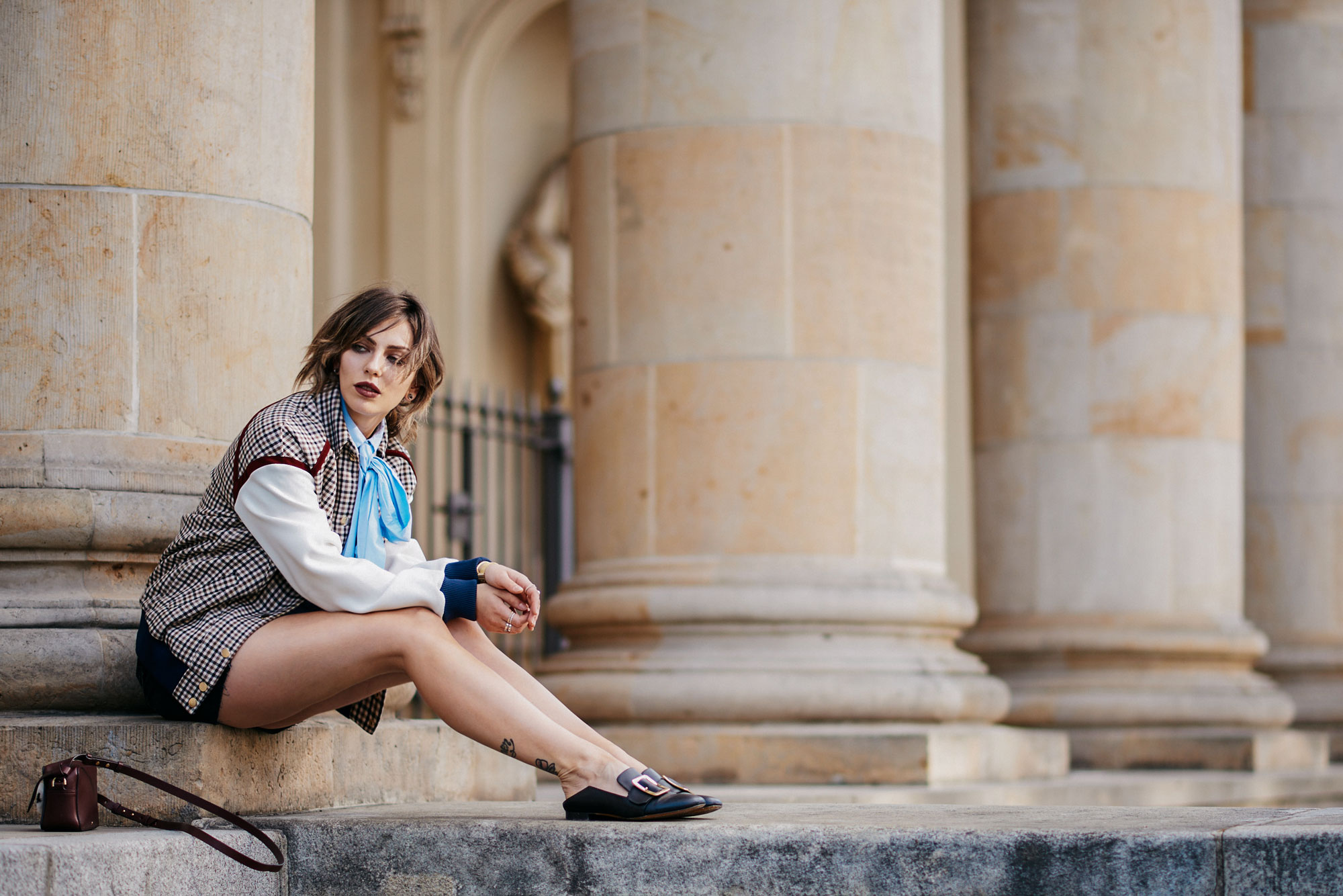 College outfit | Blogger Street style from Berlin | wearing: black jeans skirt, blouse with a bow, college jacket from Baum & Pferdgarten | furry bag from Anya Hindmarch with eyes | Bally mules | style: effordless, college, sporty, sexy, conservative