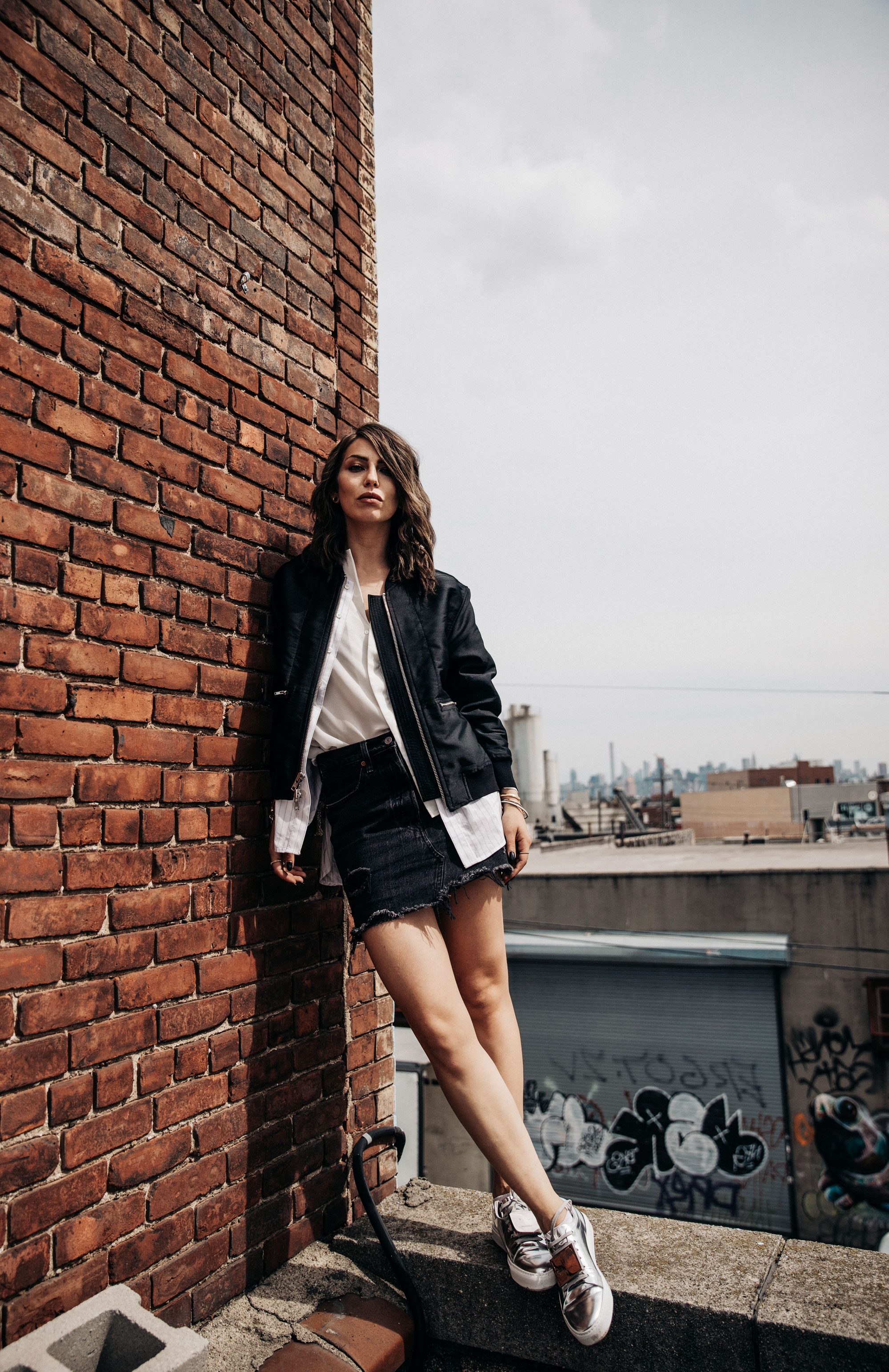shooting on a rooftop in Brooklyn, NYC | New York | fashion | Editorial | Style | blogger Masha Sedgwick | products: Adriana Metallic Sneakers from Acne Studios, bomber jacket from 3.1 Phillip Lim, black denim skirt from  Levi's | photos: Theresa Kaindl | topic: Random Facts | edgy, sexy, sporty, grunge, cool, casual
