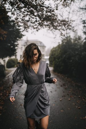 Fashion Editorial via blogger Masha Sedgwick | mood: foggy, moddy, dark woods, spooky, Halloween, festive, vintage | grey party dress via Designers Remix (sustainable) | Location: Beech Hill House Hotel in Northern Ireland (Londonderry) |  in the movement, running, fog