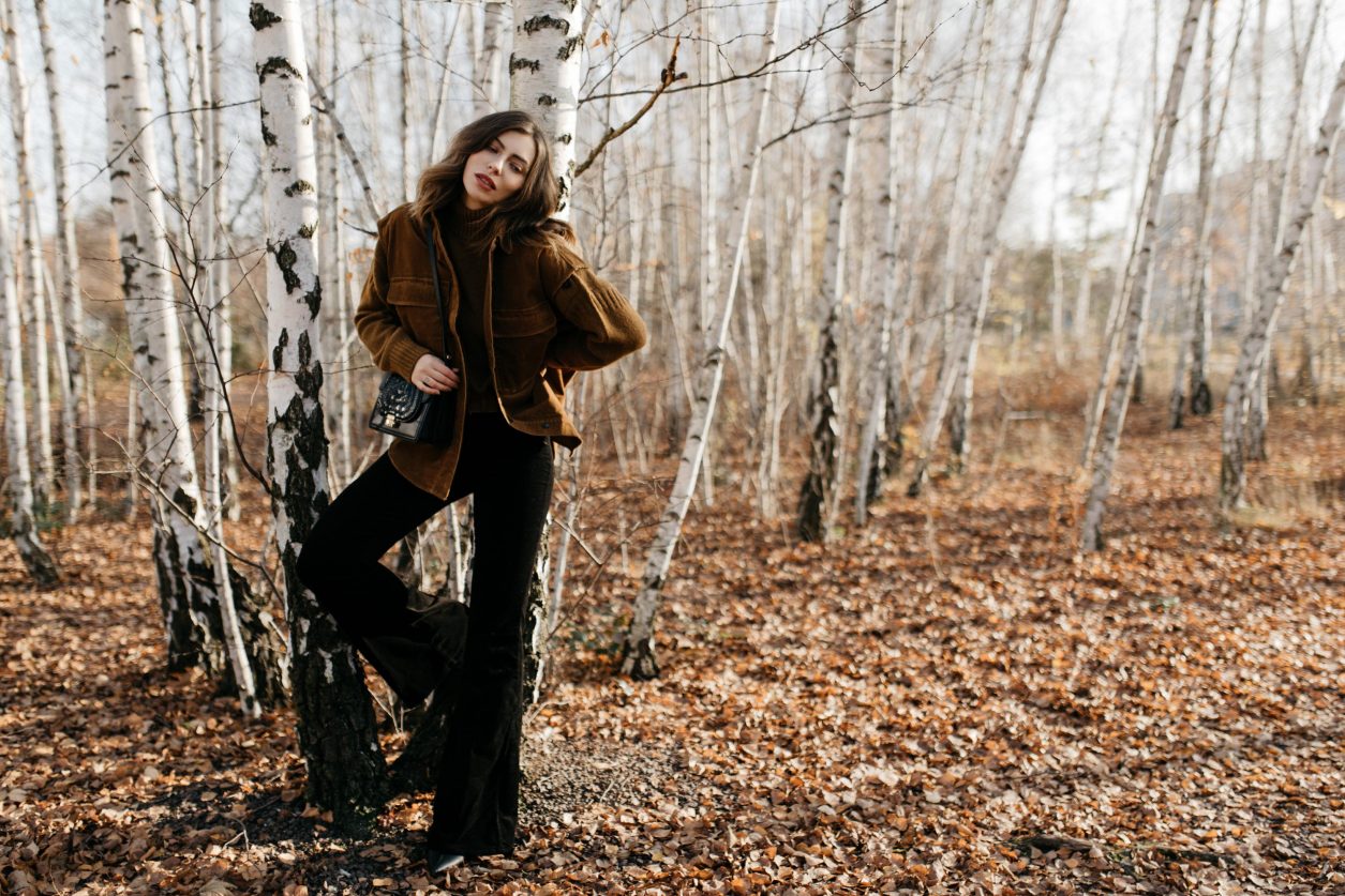 Streetstyle editorial by Masha Sedgwick | Fall winter country style outfit, wearing  tobacco Closed pullover, tobacco cord west by Closed, bootcut jeans by J Brand, brown Escada belt, black black leather cross body bag By Malene Birger | Berlin photo spot: birch park