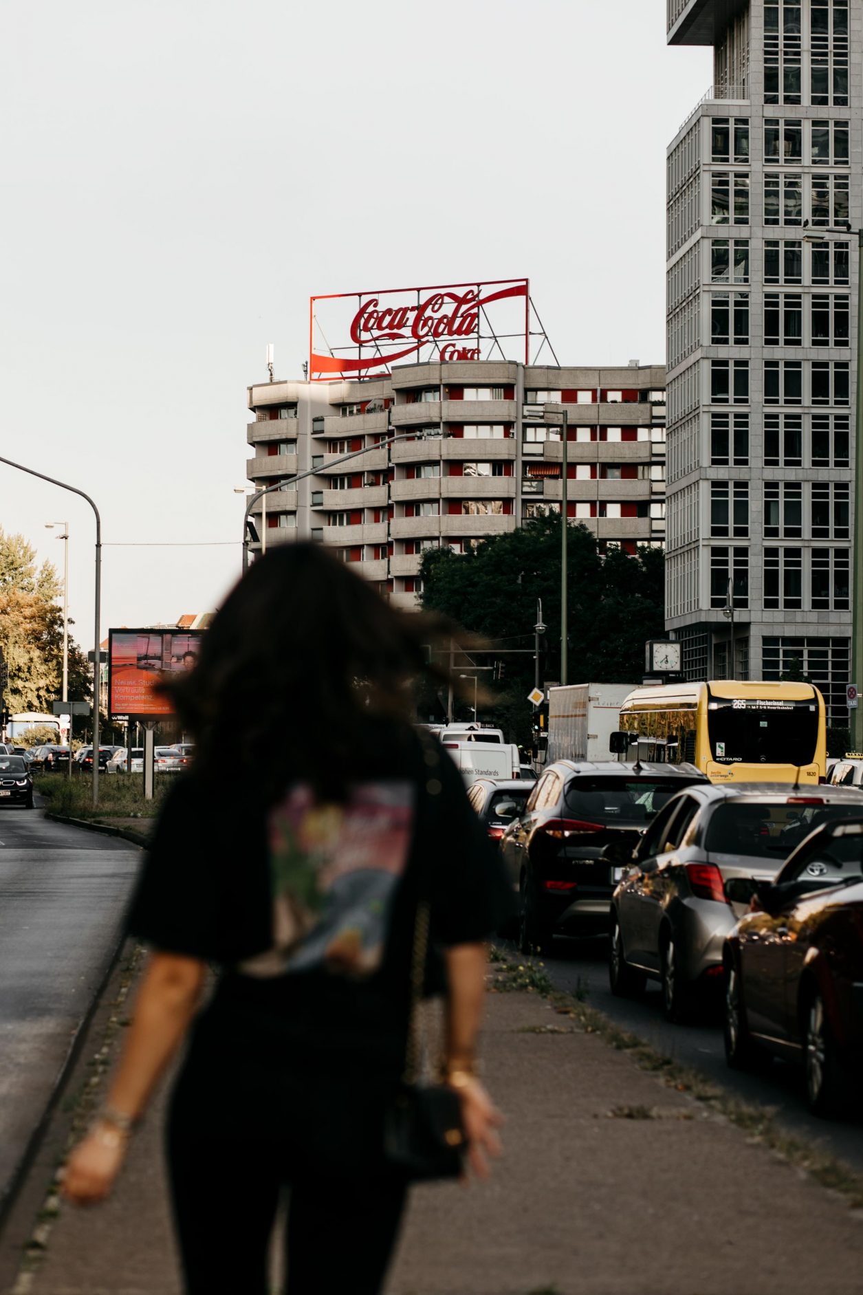 Streetstyle with Masha Sedgwick | Berlin fashion and beauty blogger | Wearing sustainable casual everyday look with chic elements: vintage Chanel bag, high heeled sandals, Armedangels sustainable jeans brand, In Private Studio printed shirt, golden high end jewelry | Streetstyle photographer Tonya Matyu